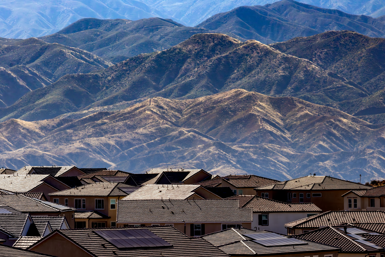 Aerial view of Denver residential neighborhoods with the mountains beyond